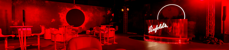 Entrance to event space.  Penfolds neon red cut out against mirrored surfaces