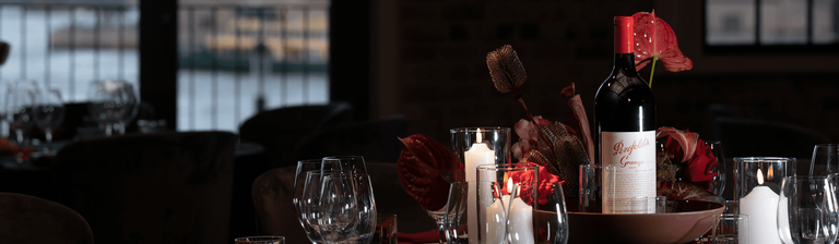 Grange bottle sits on table with Sydney Opera House visible through window behind