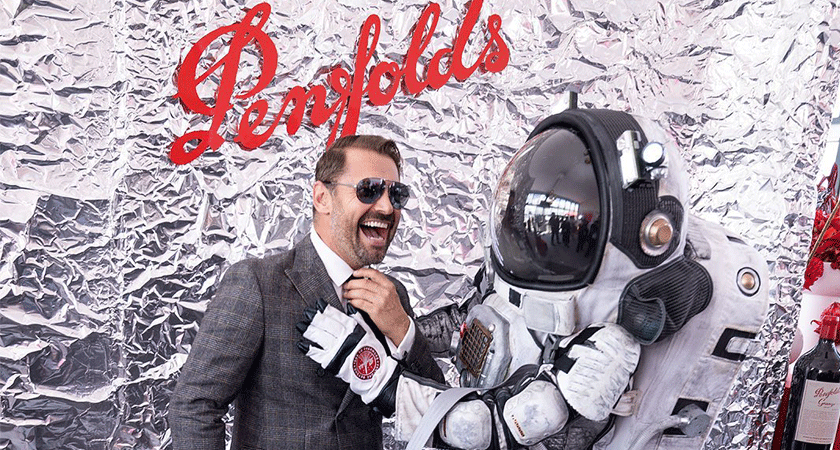 Dan Macpherson laughs posing with astronaut