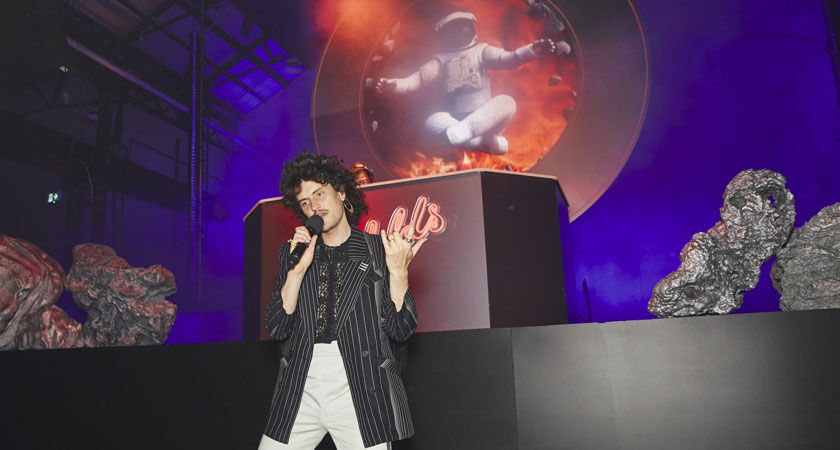 Monte Morgan from Client Liaison on stage mid performance 