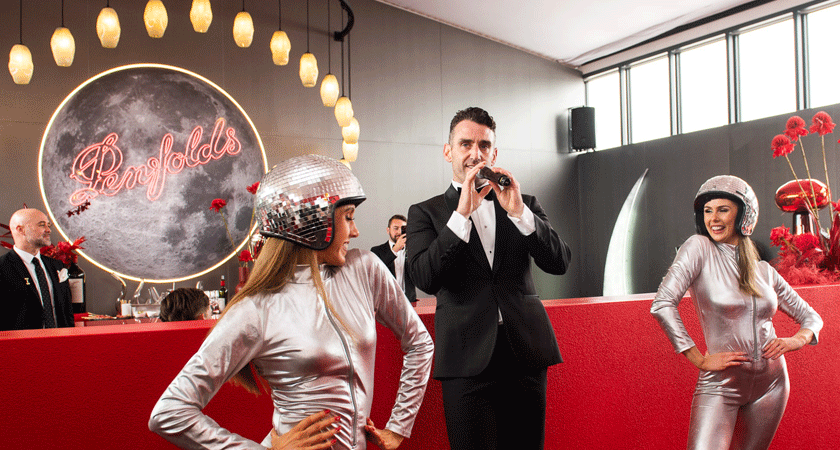 live performance in marquee.  Two dancers wear space-inspired disco ball helmets