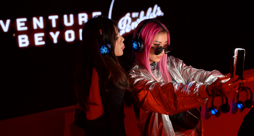 Two guests pose while taking a selfie