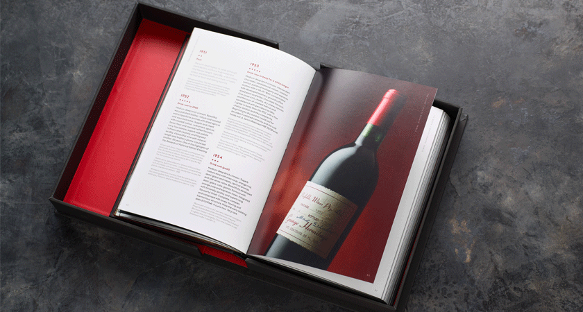 Open book.  Close up of a Grange bottle on the left page and text on the right