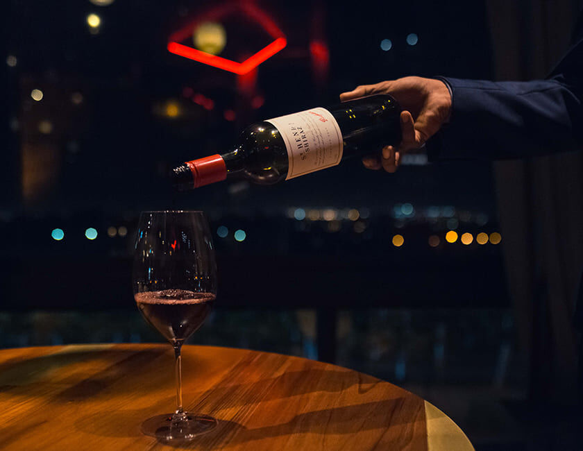 Two hands holding shiraz grapes