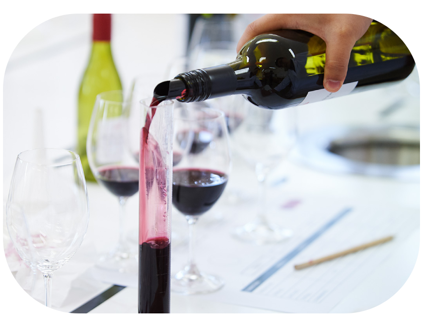 Red wine being poured into test tube