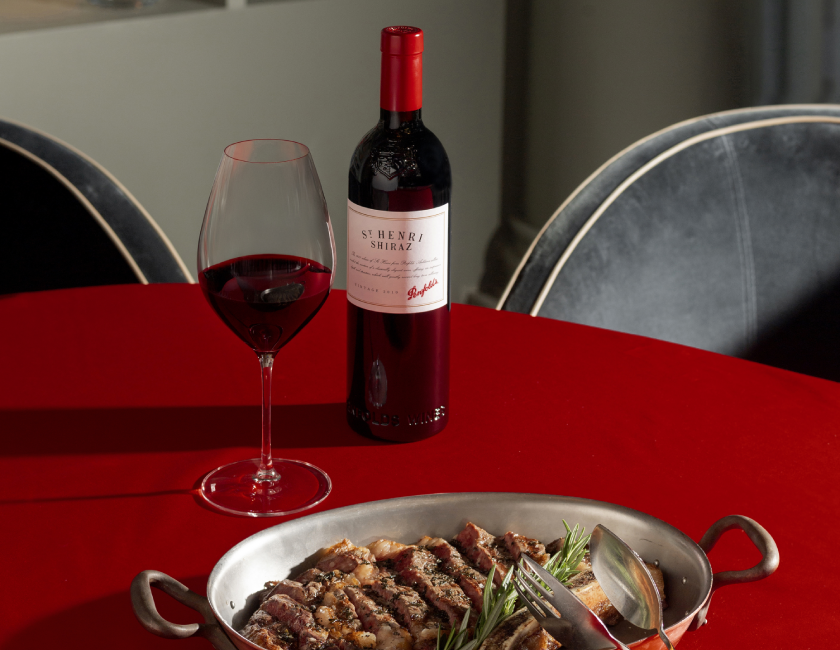 Penfolds St Henri Shiraz alongside a plate of meat